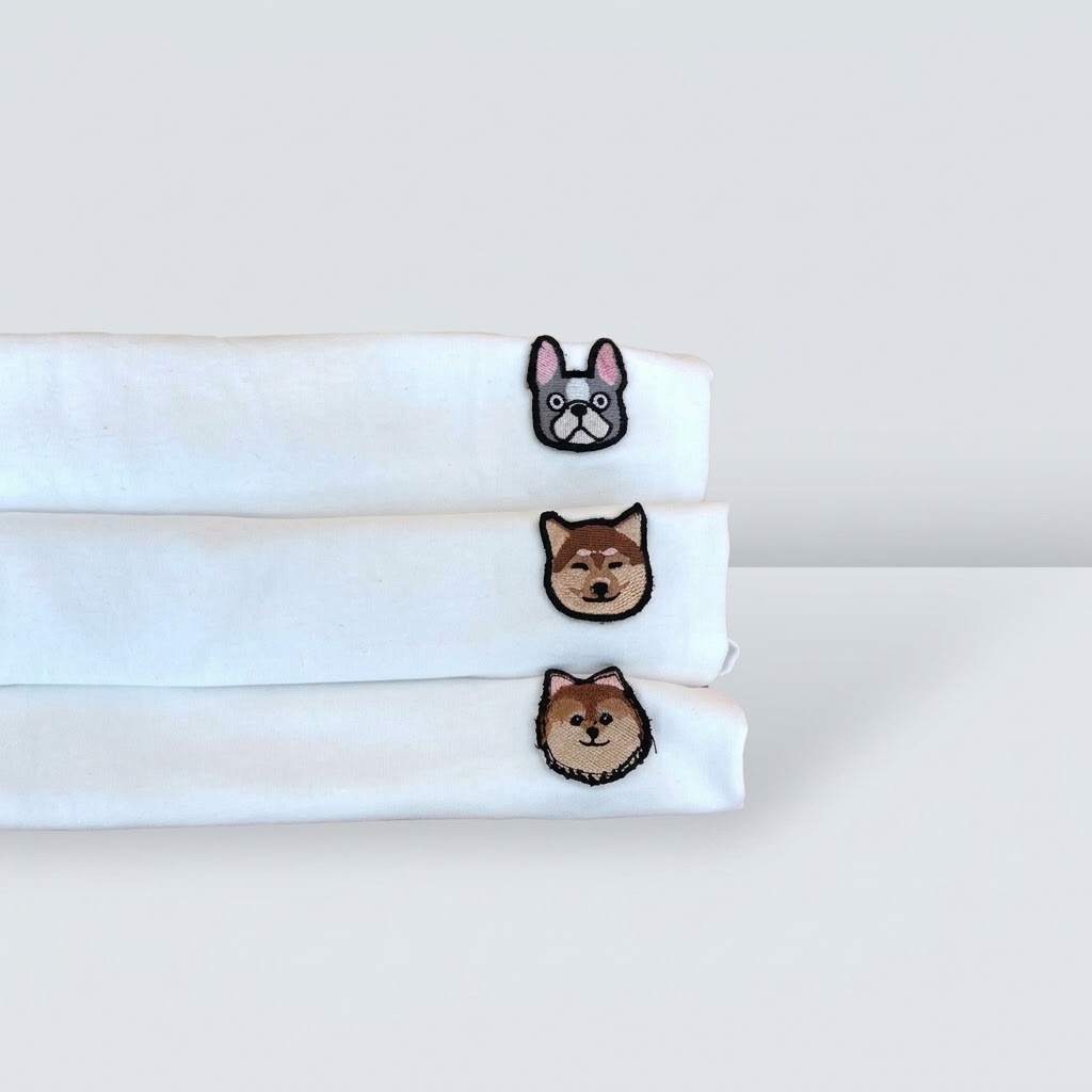 The Originals — white ADC tees with embroidered French Bulldog, Shiba and Pomeranian patches